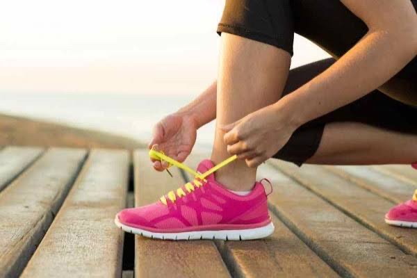 Coureur qui laçe ses chaussures, prêt à reprendre la course à pied après une blessure