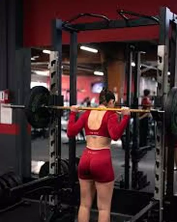 Person performing a loaded squat